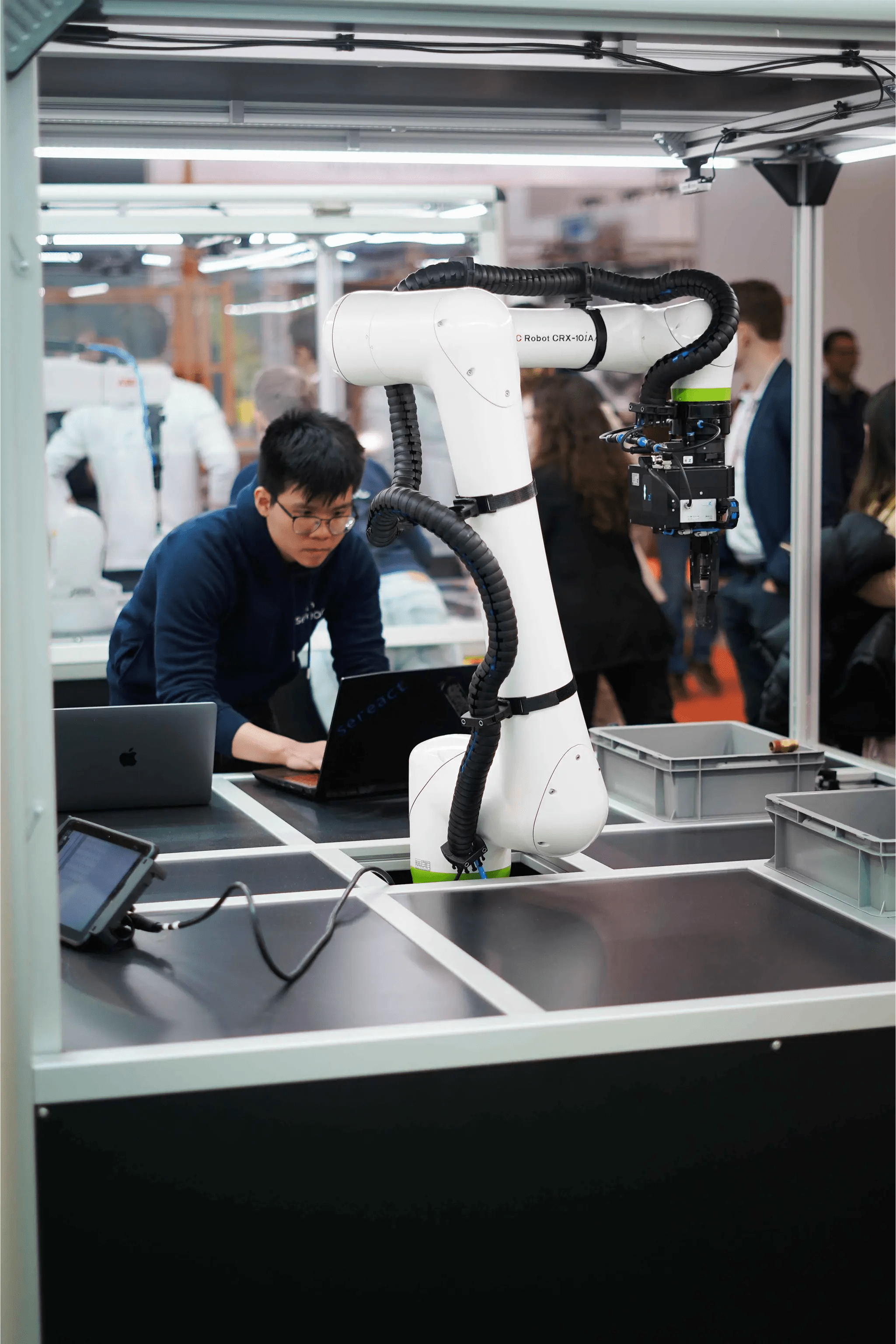Industrial warehouse with technician and robotic arm